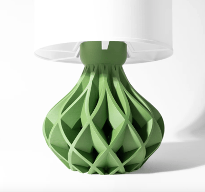 a green lamp shade with a white lamp on top