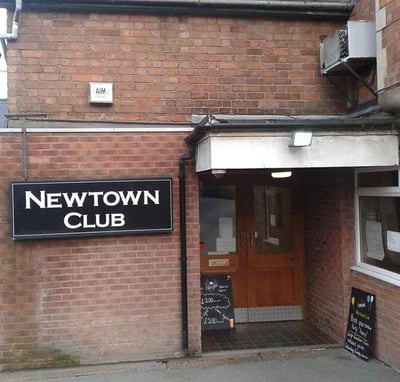 a sign that says new town club