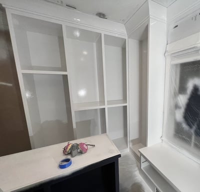 Custom refinished white built-in closet with a smooth, professional finish, enhancing storage space 