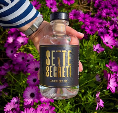 a person holding a bottle of selte selte segreit