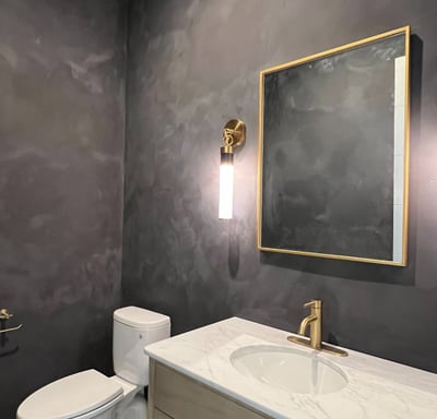 Moody black limewash bathroom with a textured matte finish, creating a sophisticated and modern spa-