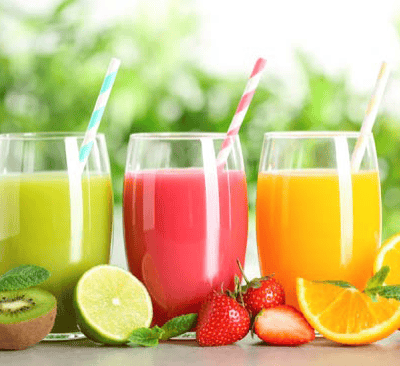 a variety of fruits and vegetables in a row of glasses