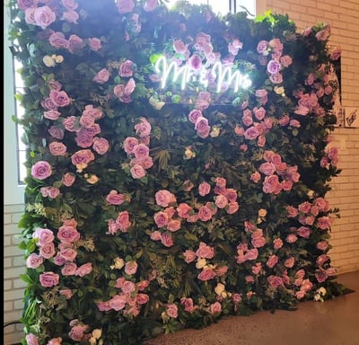 Juliette flower wall with a Mr & Mrs neon sign for a wedding reception at the Eglington West Gallery