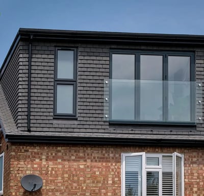 a redesigned loft with a large window 