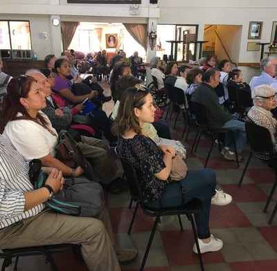 a group of people sitting in chairs in a room