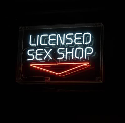 neon sign that reads licensed sex shop