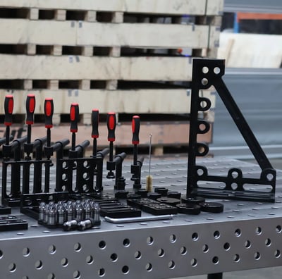 a bunch of fixture tools on a welding table