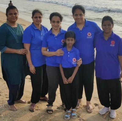 a group of people standing on a beach