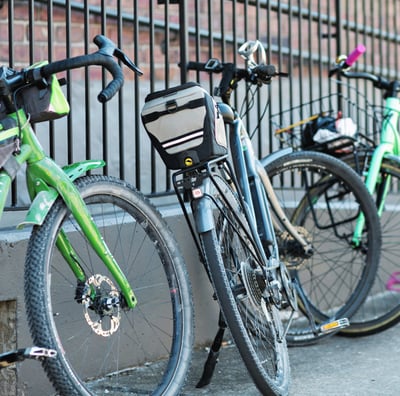 Bikes leaned up against a fence