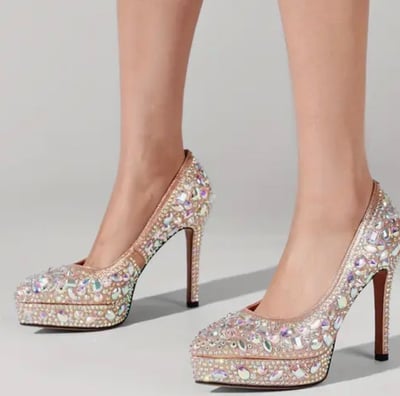 a woman's legs and heels wearing a pair of shoes