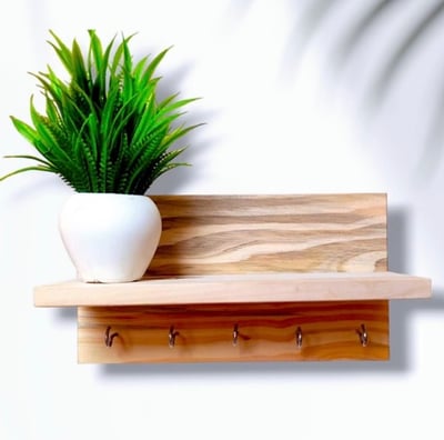 a wooden wall hung shelf with hangers