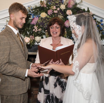 Vintage style Hertfordshire Bride & Groom holding hands as they say their vows