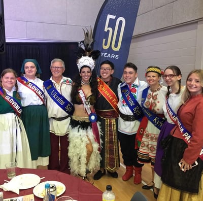 a group of people standing around a table
