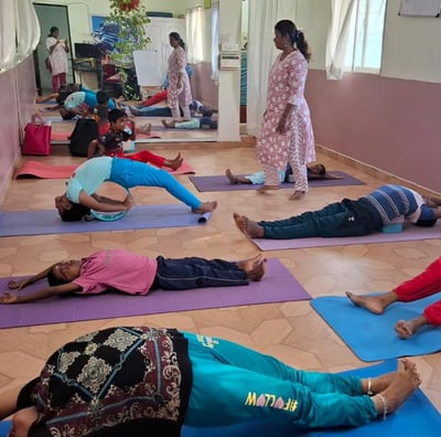 a group of people doing yoga exercises on a mat