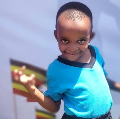 a young boy with a blue shirt and black shorts