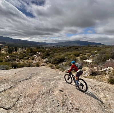 a person riding a bike on a rocky surface