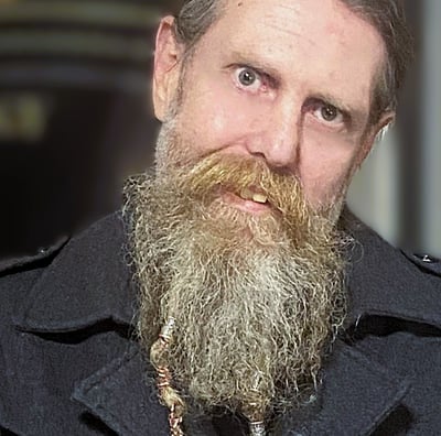a bearded man posing