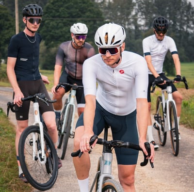 a group of men riding bikes on a path