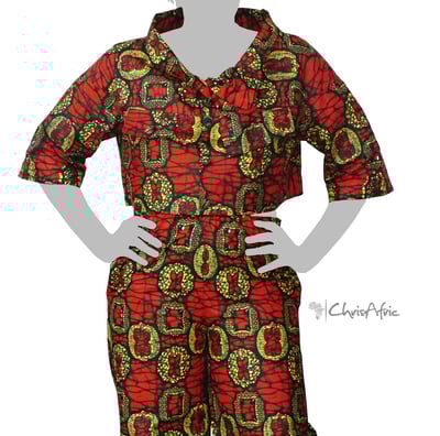 a woman in a red and green patterned blouse and pants