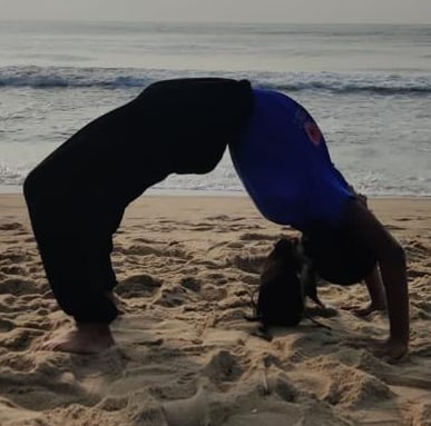 a person doing a handstand on a beach