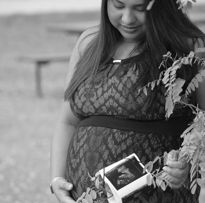 a pregnant woman in a lace dress and a flower crown