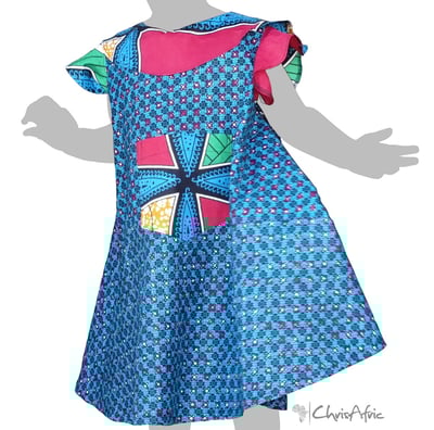 a little girl in a blue dress with a bow tie