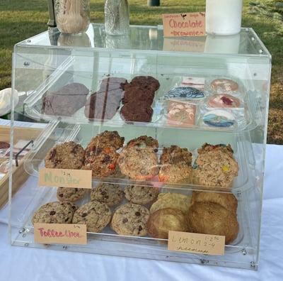 many assorted delicious baked goods in a case baked fresh daily