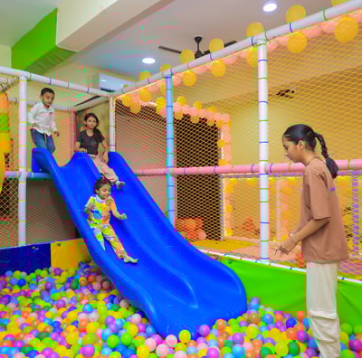 Kids sliding in the ball pool