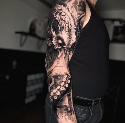 Kraken and lighthouse black and grey outer sleeve tattoo