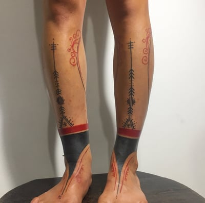 An handpoke tattoo featuring mentawai art tribal tattoo inspired, tattoo on legs