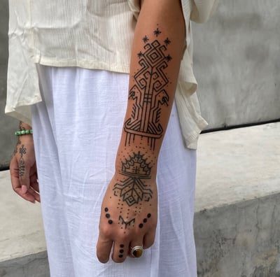 An handpoke tattoo featuring art ornaments hand weaving patterns NTB inspired, tattoo on sleeve