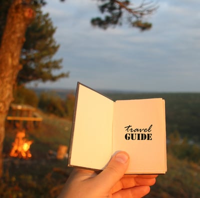 a person holding a book with a bookmark on it