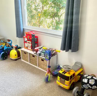 an organized playroom with ride on toys