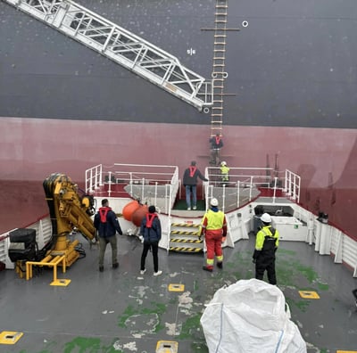 a large ship with a crane on the deck
