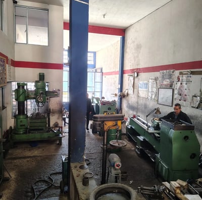 a man working on a machine in a factory