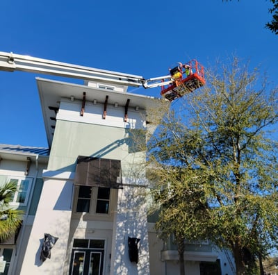 rofessional exterior high-rise painting using lift equipment by Garnet Painting & Remodeling in Douglas, GA.