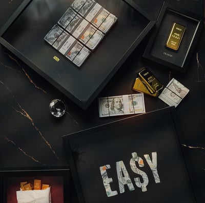 frames with money and gold bars in a marble background