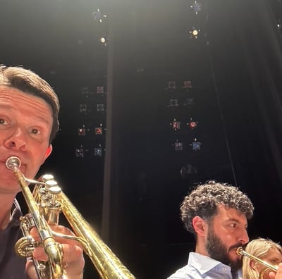Trumpeters George Chase and Chris Coletti warm up before a dress rehearsal for a chamber orchestra.