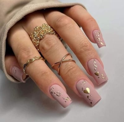 a woman's hand painted nails with gold foil and glitter