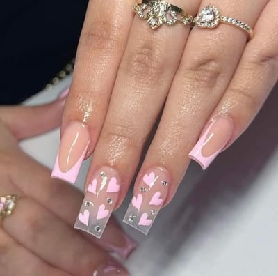 a woman's hand painted nails and a ring