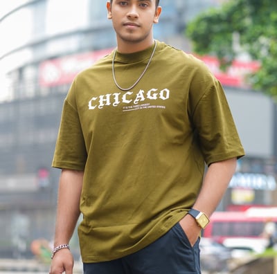 a man in a green shirt and black pants