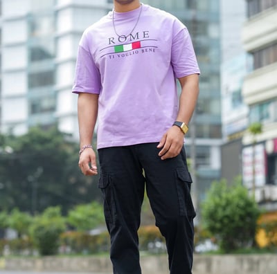 a man in a purple shirt and black pants