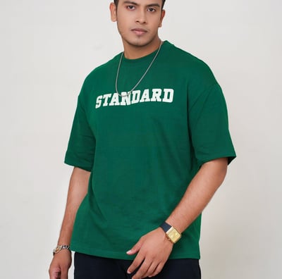 a man in a green shirt and a necklace