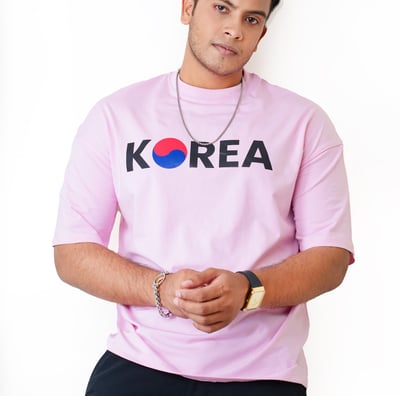 a man in a pink shirt and black pants