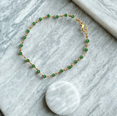 a bracelet bracelet with a white and green beaded bracelet