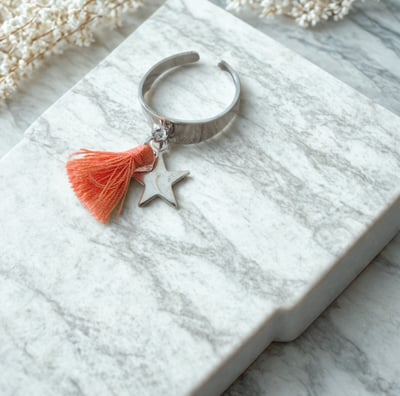 a ring with a starfish charm and a starfish charm