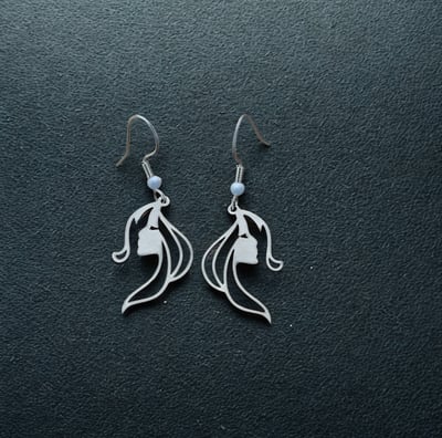 a pair of earrings with a flower on it