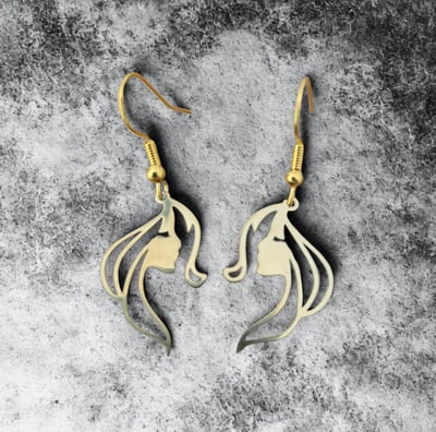 a pair of earrings with a horse head and a horse head
