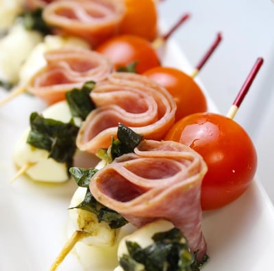 a long - terme of meat and vegetables on a white plate