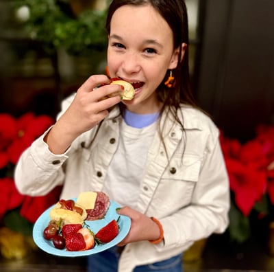 Girl enjoys eating little smoky in a Smoky Lil Bun at a party.